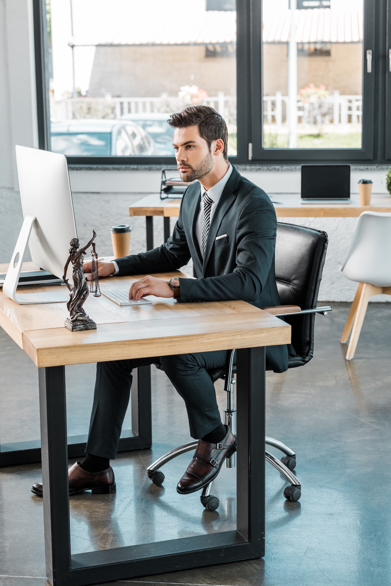 handsome lawyer working with computer at table in office